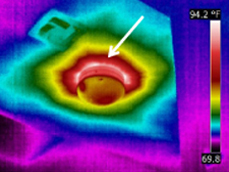 Air leakage at a ceiling light during blower door test 